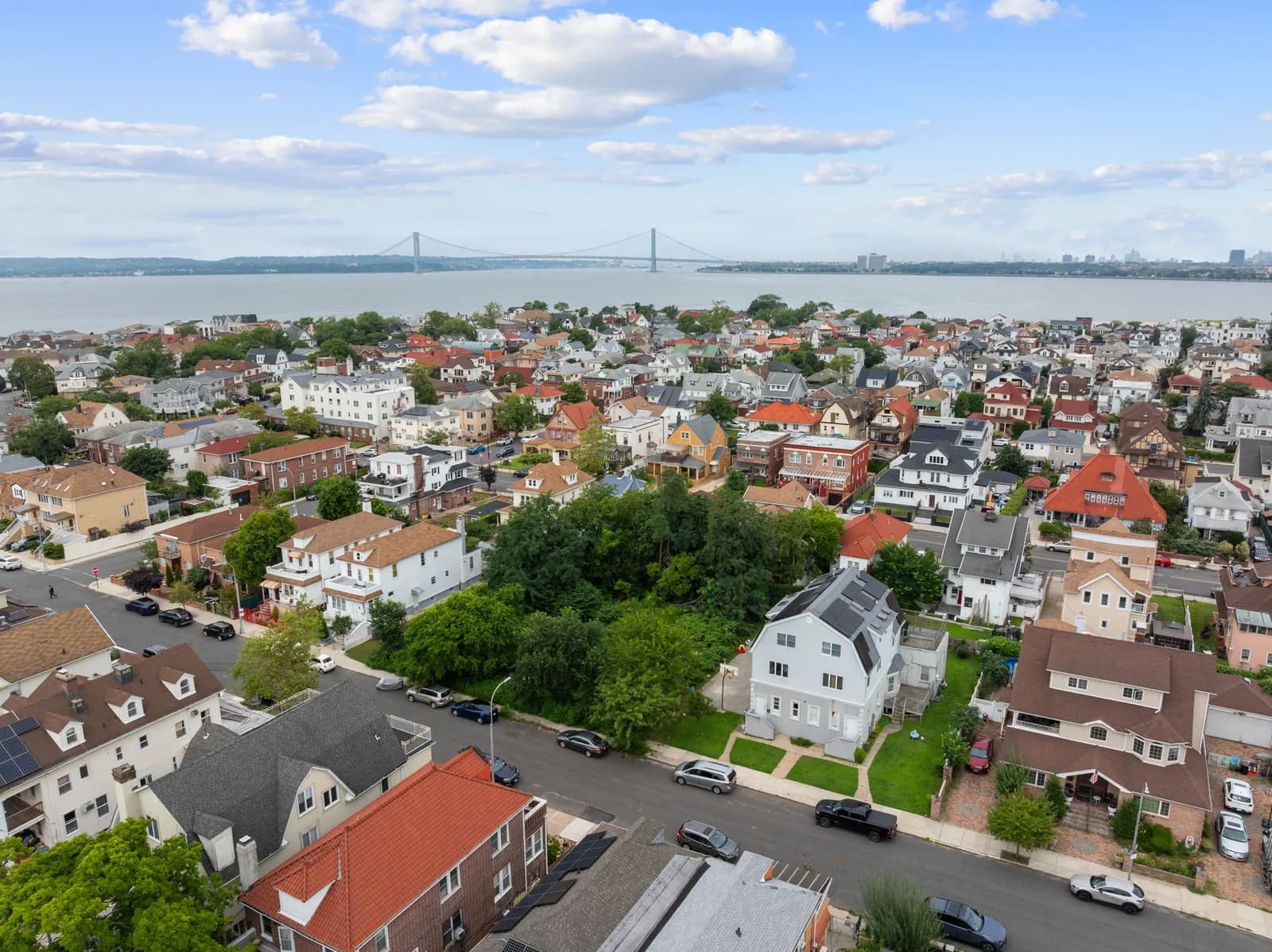 Drone view over the neighborhood toward the Verrazzano Bridge, Coney Island