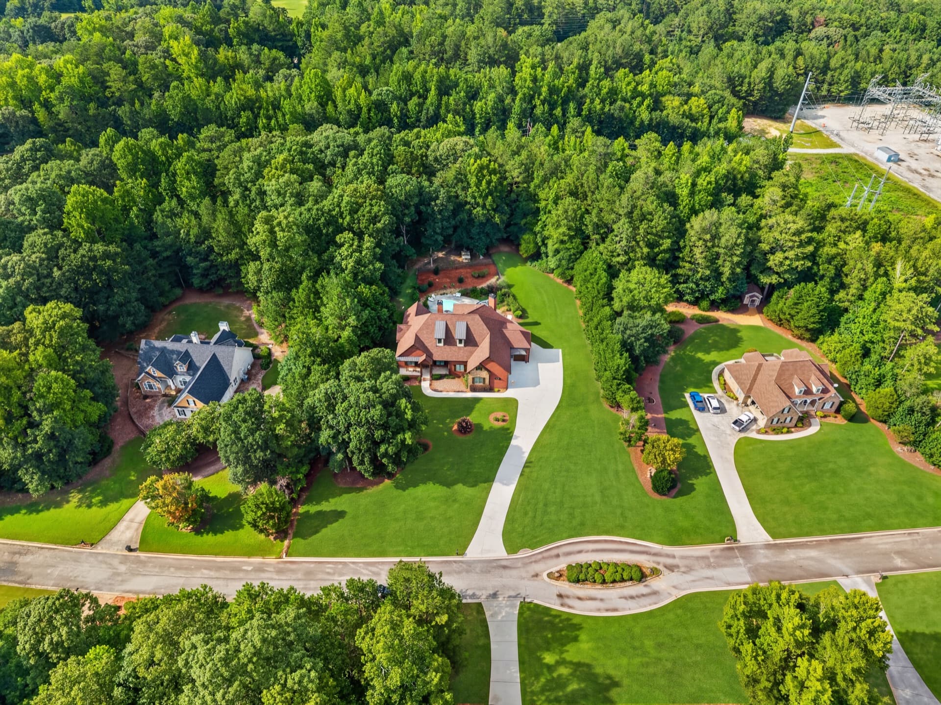 Aerial view of estate homes surrounded by forest