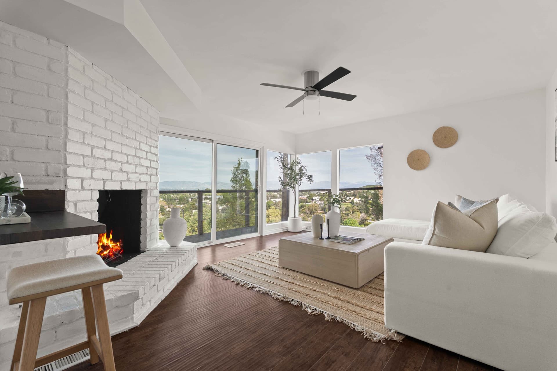 Living room with a white brick fireplace and few objects