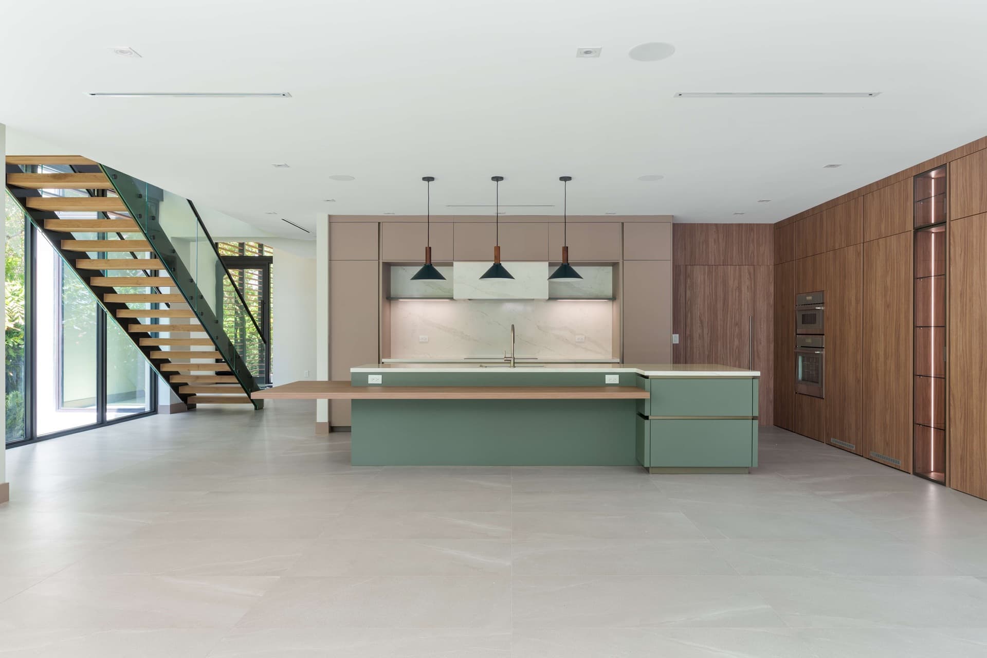 Open-plan kitchen and living space with a floating staircase