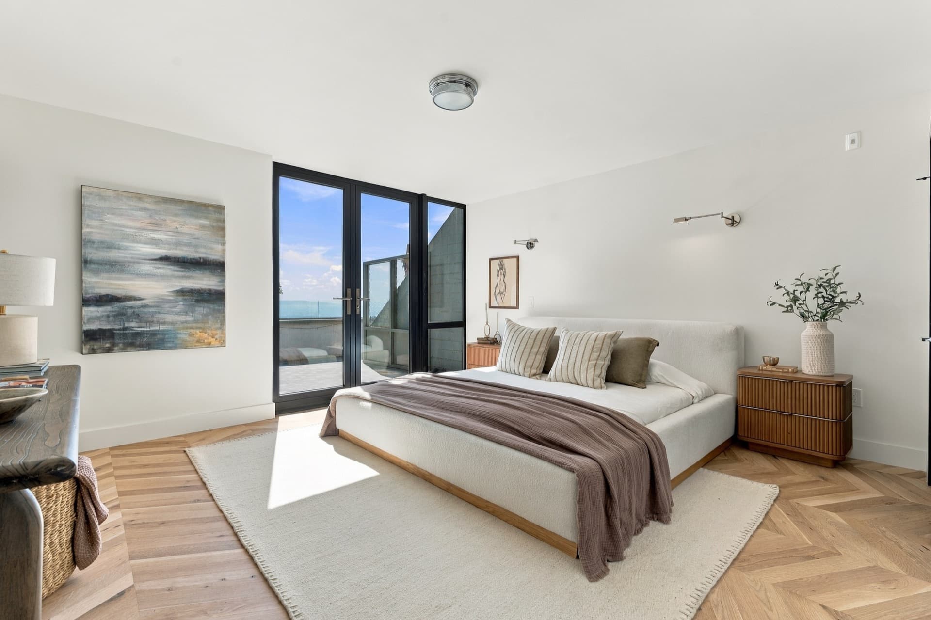 Bedroom with a made bed and balcony doors